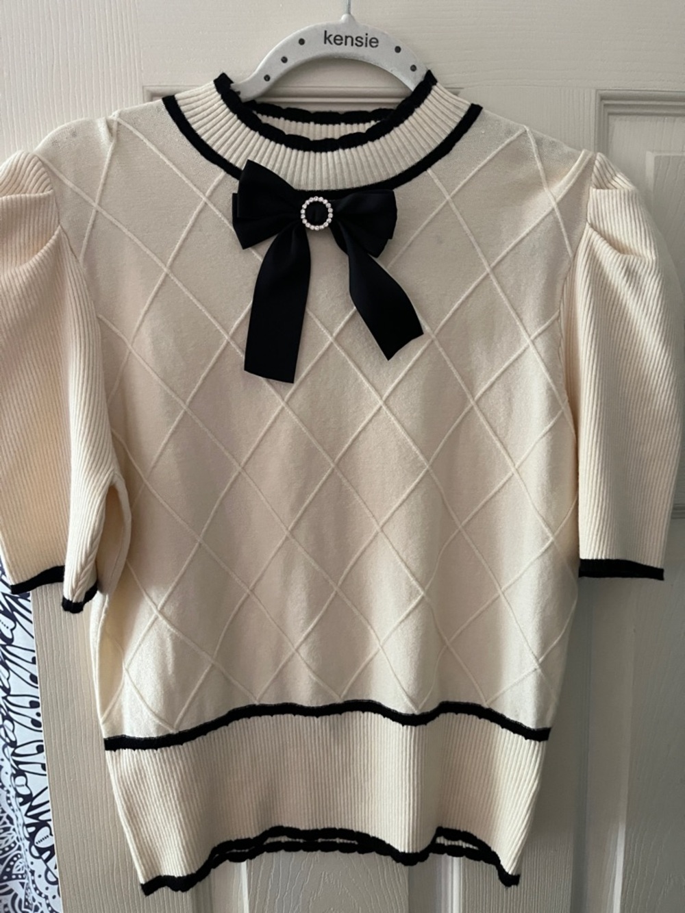 Ontwelth Cream Short sleeve Sweater with Black Trim and Black Bow Accent